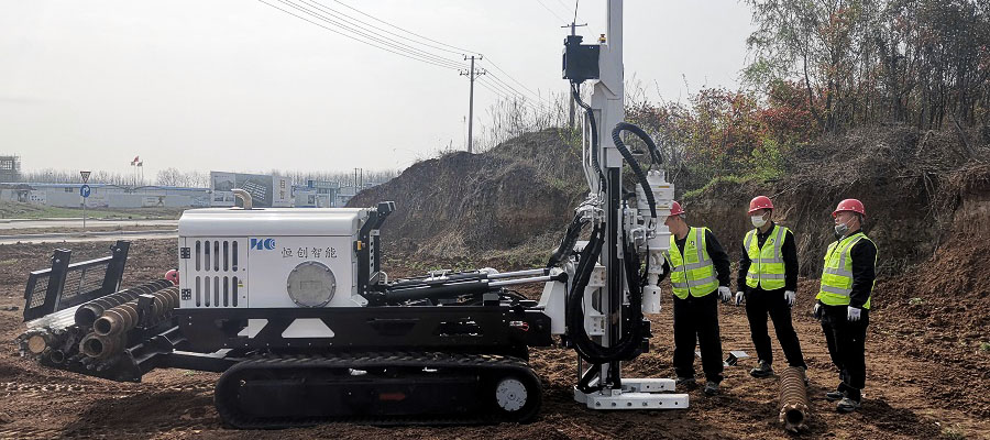 Tracked soil sampling drill rig taking soil samples in a field