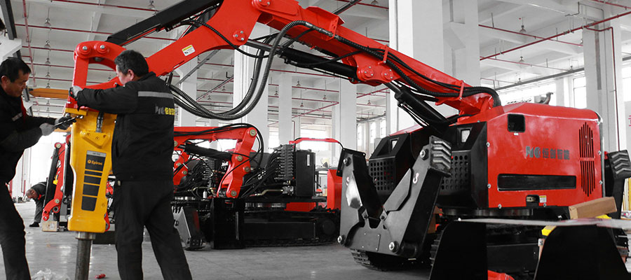 Technicians perform last minute checks and adjustments on a large hydraulic demolition robot before it is shipped to a cement factory for refractory brick removal.