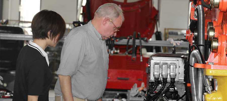 Engineers calibrate sensors and test actuators on a robotic brick dismantling system destined for installation in cement plant rotary kilns.