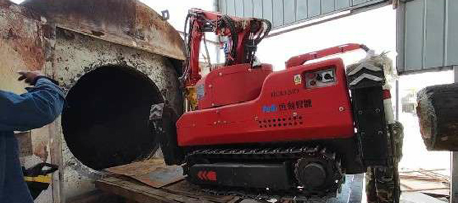 A close-up of the HCR120D Demolition Robot's hydraulic crusher breaking up debris inside the cramped interior of a rotary kiln.